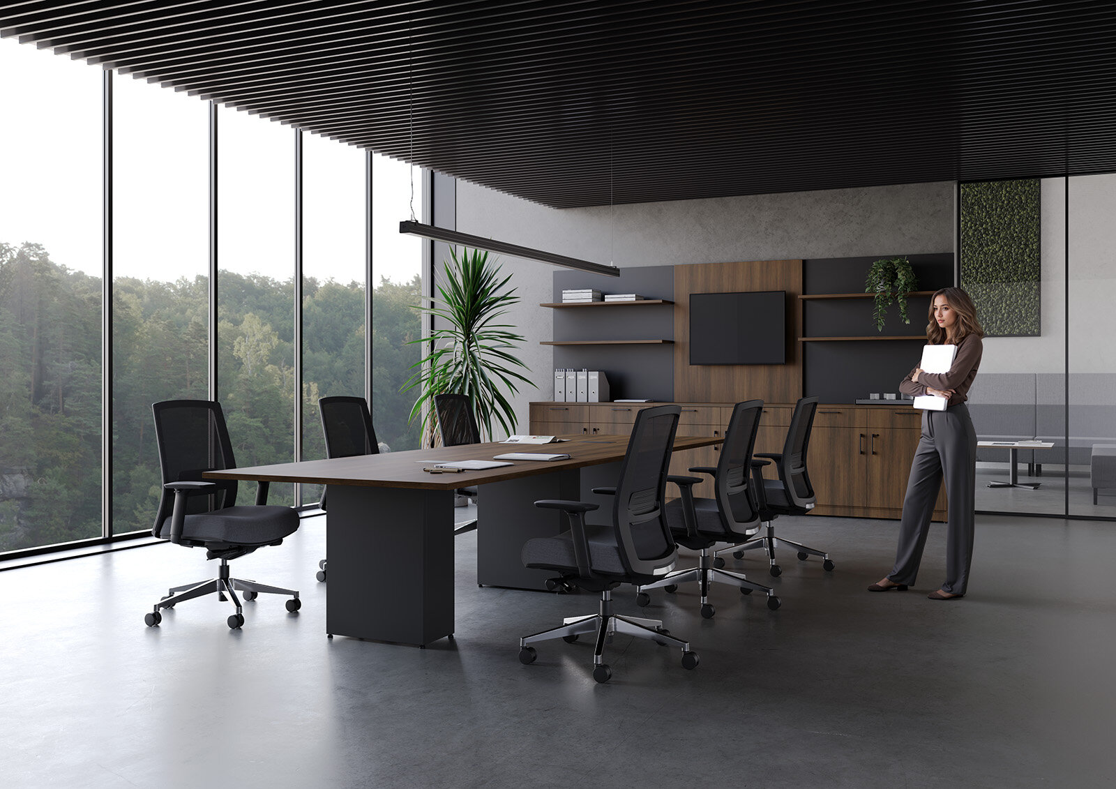 woman standing in modern office space with large windows